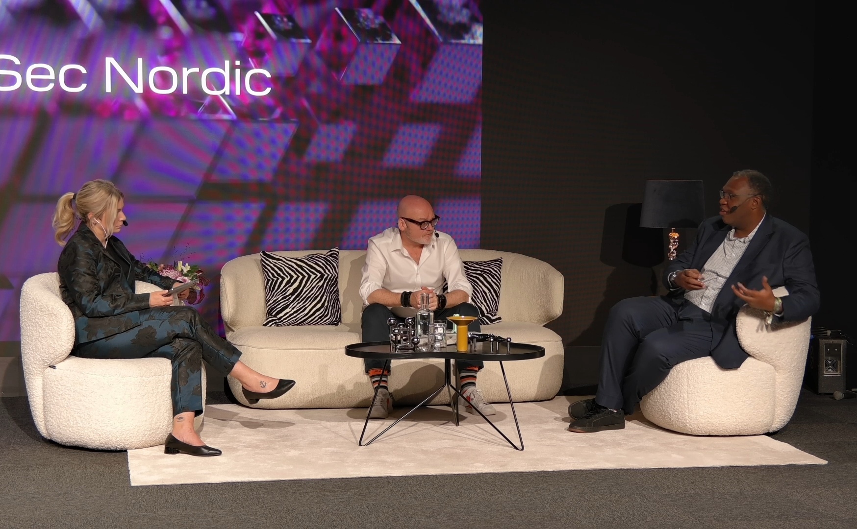 CyberSec Nordic panel — Rodney on stage with two other panellists, event signage visible