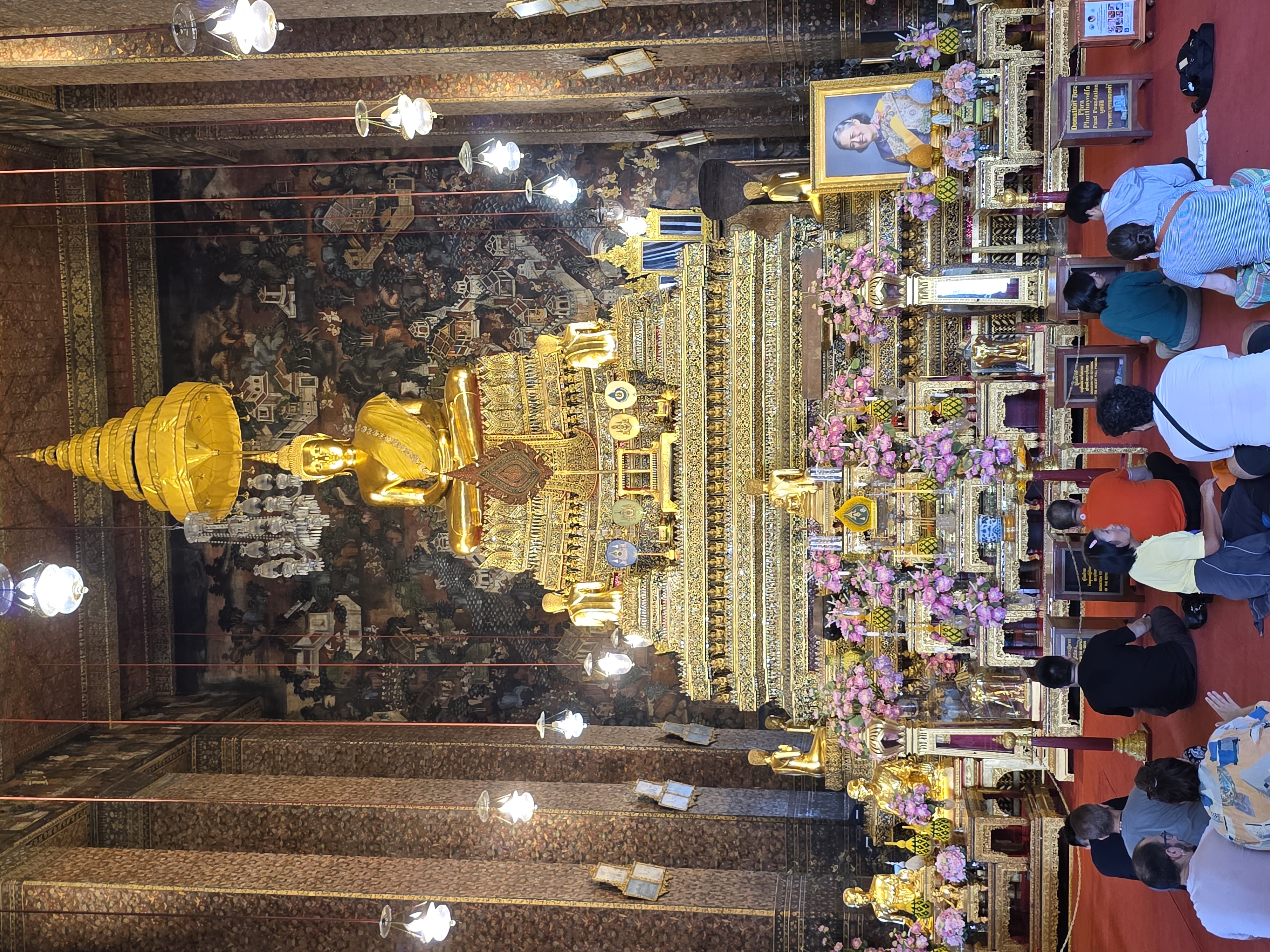 Wat Pho prayer hall interior, golden principal Buddha, worshippers seated