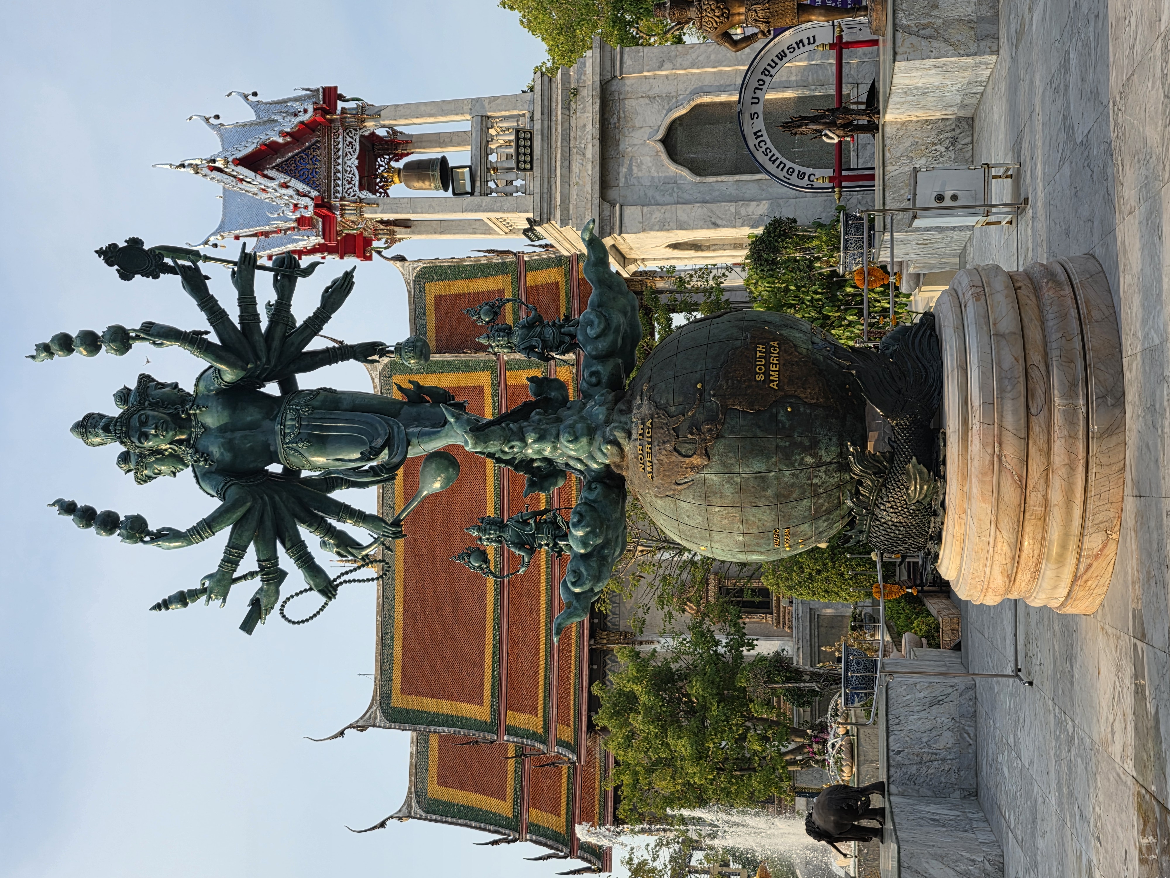 multi-armed bronze deity on globe, Wat Intharawihan