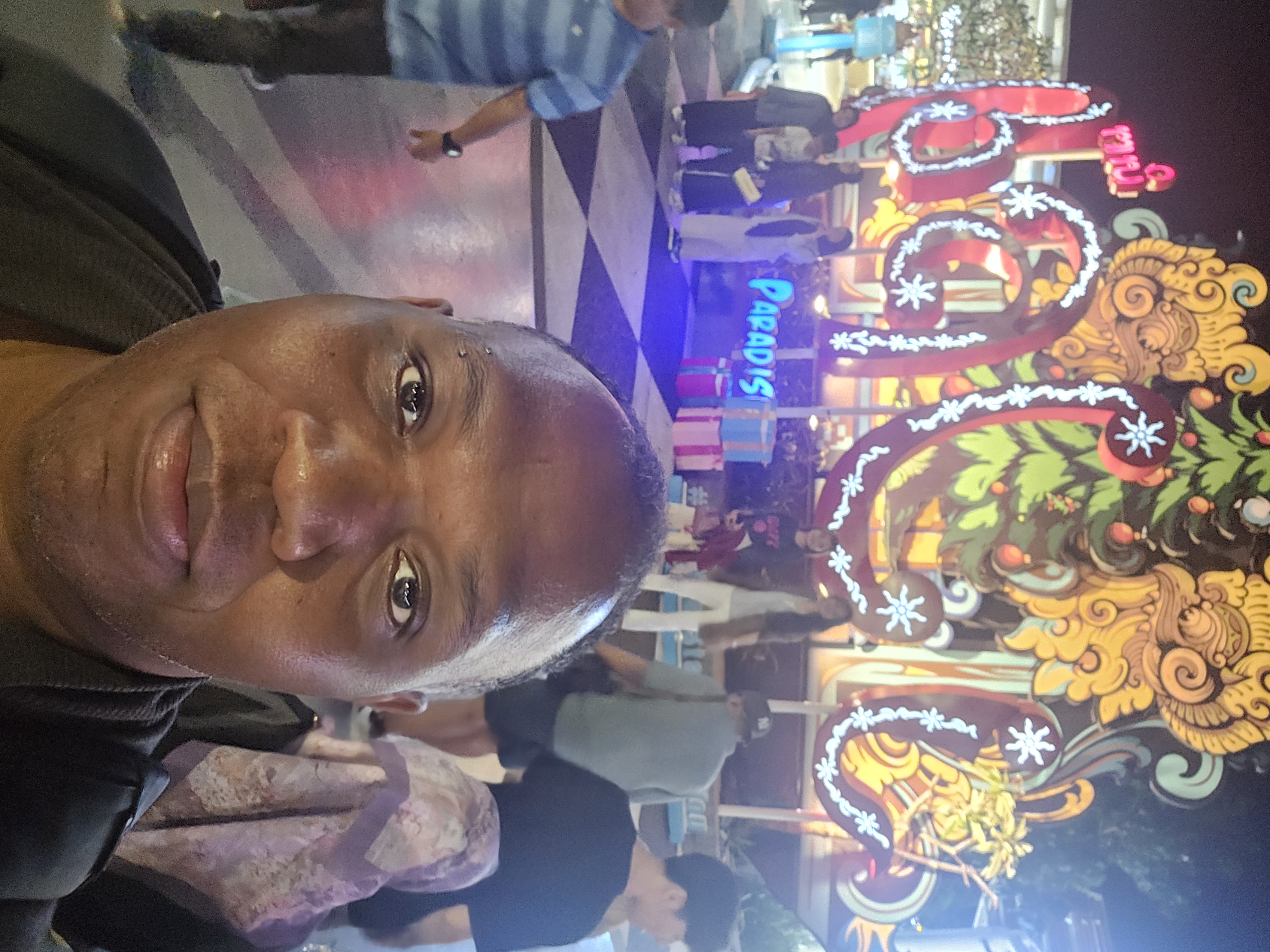 Rodney in front of ornate Balinese Christmas display at night