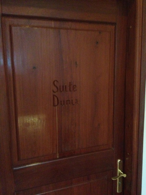 "Suite Dunia" — carved wooden door at the hotel, Zanzibar