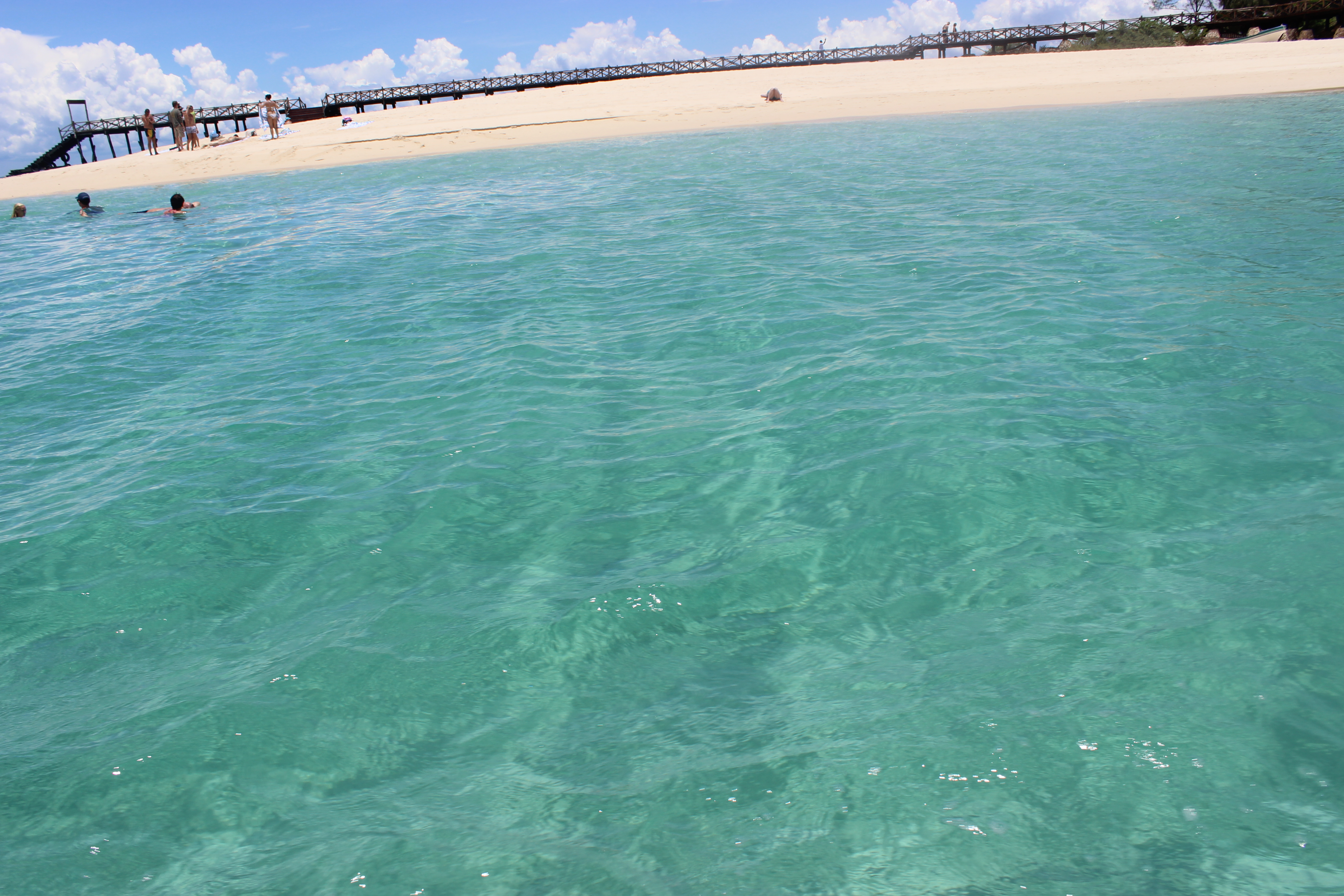 Safari Blue sandbank from the water — turquoise sea, white sand, wooden pier