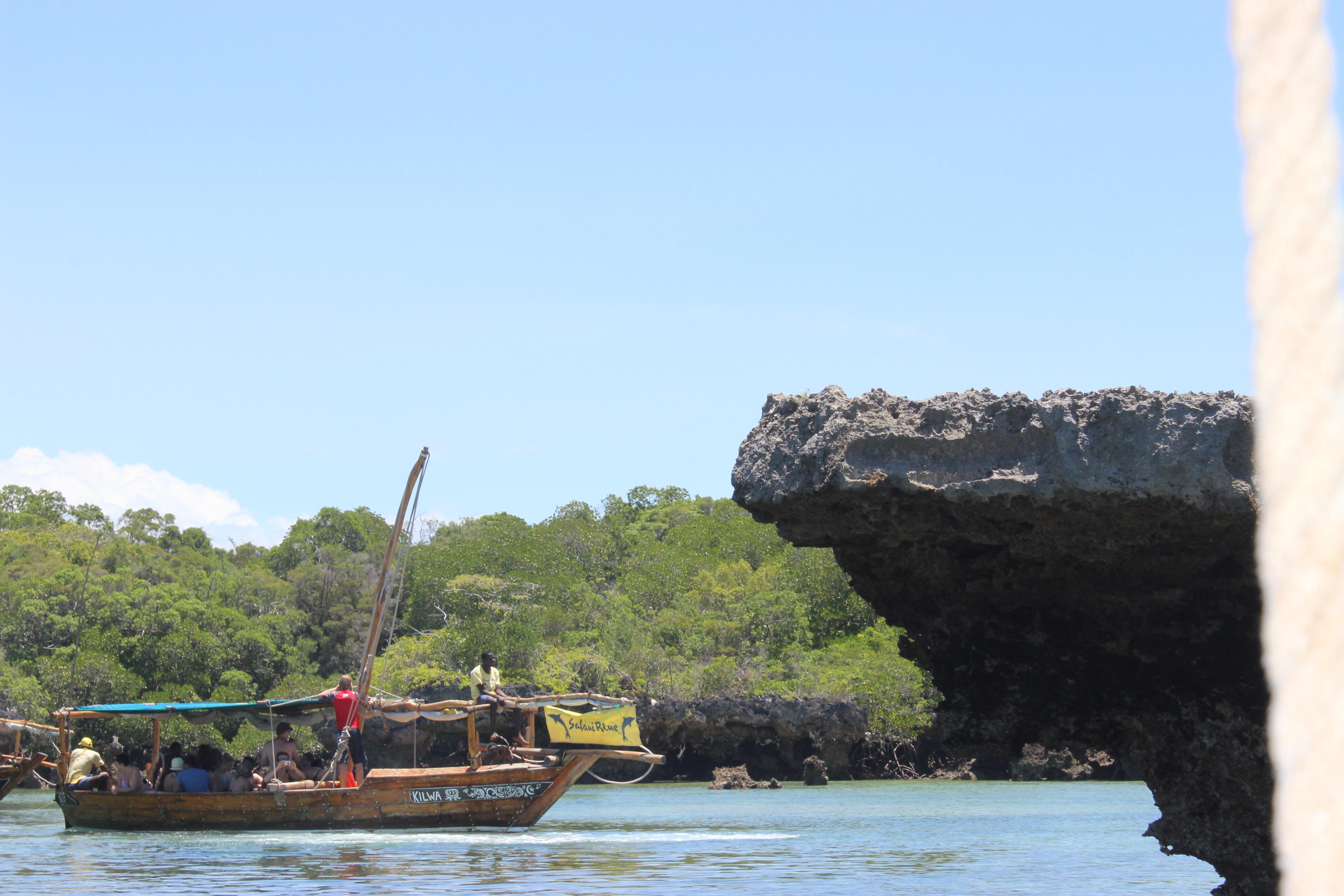 The Safari Blue dhow "KILWA" passing under a coral rock arch