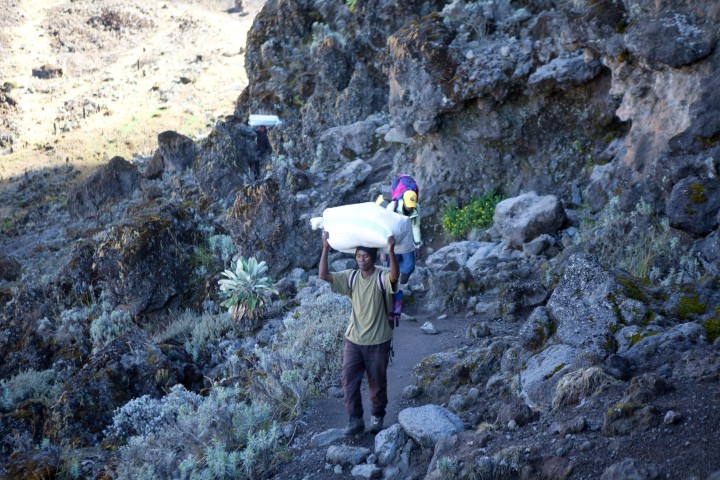 Porters on the move — loaded and heading uphill