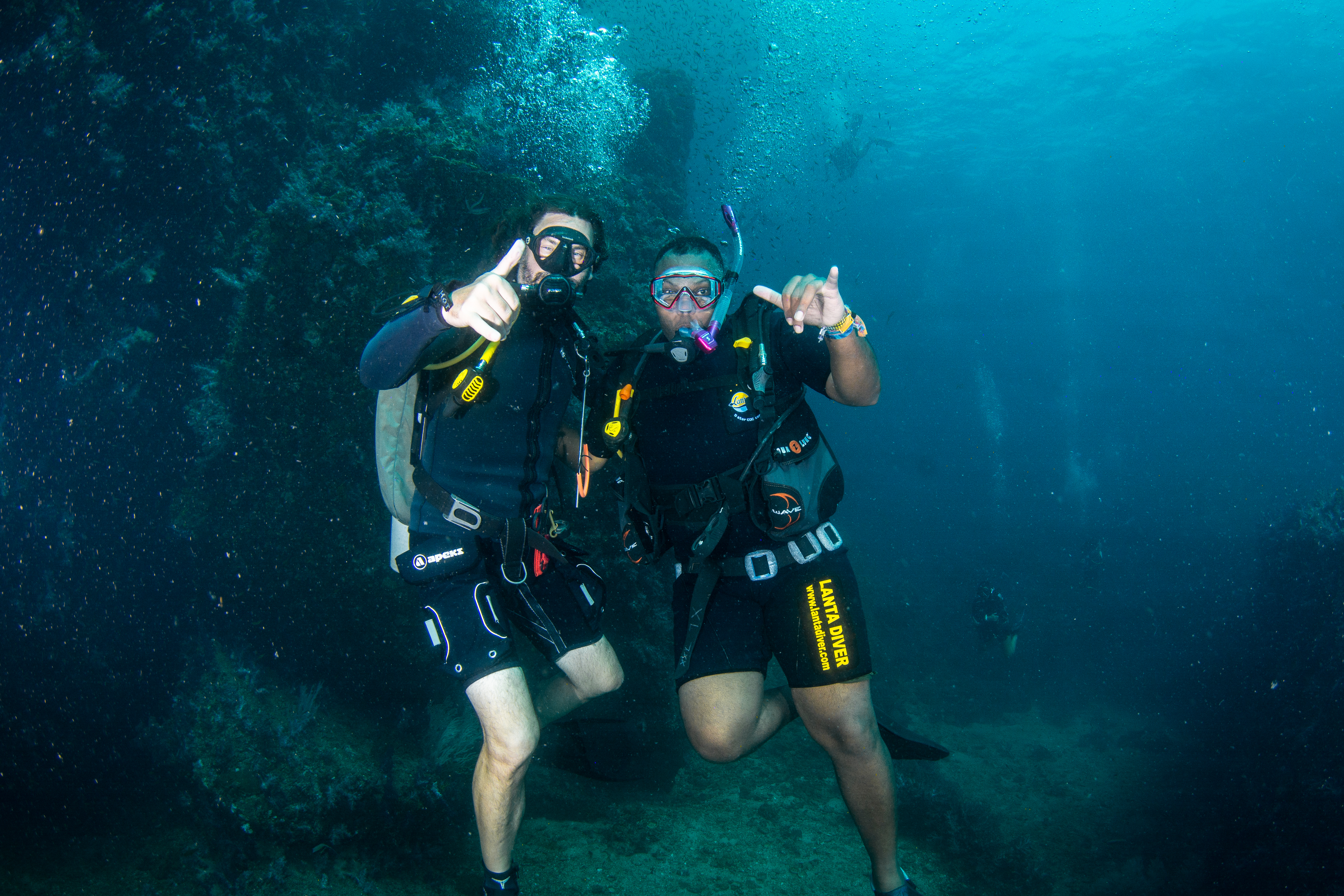 Rodney with instructor, thumbs up underwater